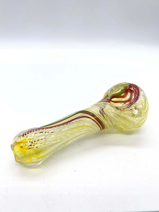 Another photo of a yellowish spoon smoking pipe against a white background, taken from another angle. The bowl and carb are now more clearly visible. Green and red stripes are visible running through the pipe, from bowl to mouthpiece.
